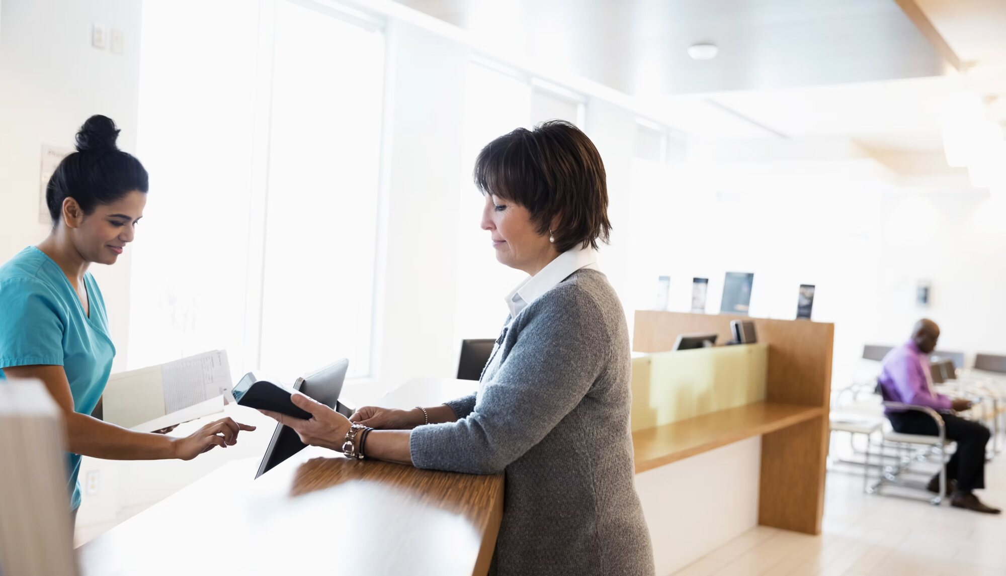 A welcoming healthcare reception desk interaction