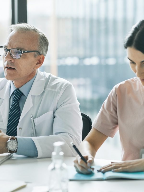 Medical Professionals at Meeting Table Medical Professionals at Meeting Table